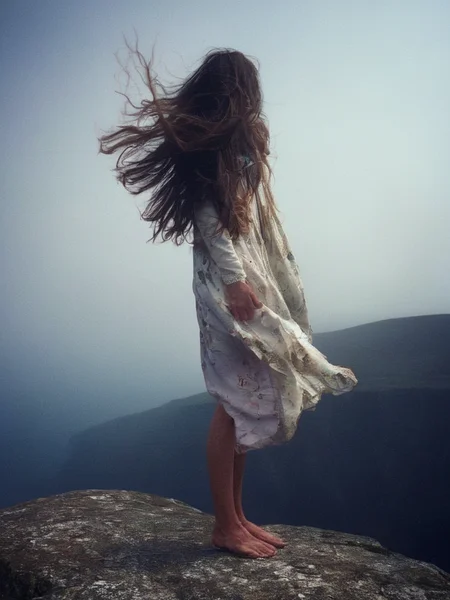 <lora:SDXL_feelings_Sa_May-v5:1> feelings, a woman standing on a cliff, dress, wind, long hair