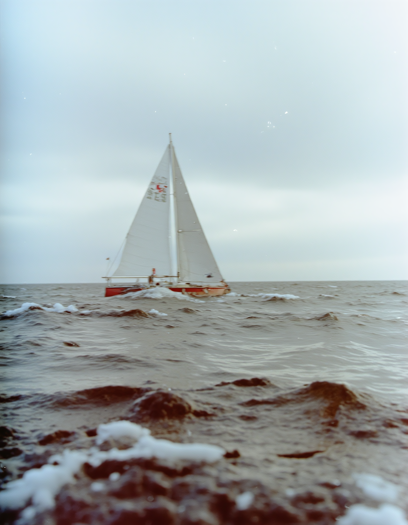 c41_hasselblad_portra400_FLUX, instagram photo of a sailboat in heavy sea, film grain, soft shadows