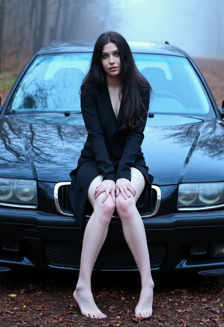 beautiful woman, posing, fashion, sitting on a bmw hood, dark long hair, model, green eyes, barefoot, feet, toe nails, blue light, fog, forest , back woods. amateurish quality, overexposed light