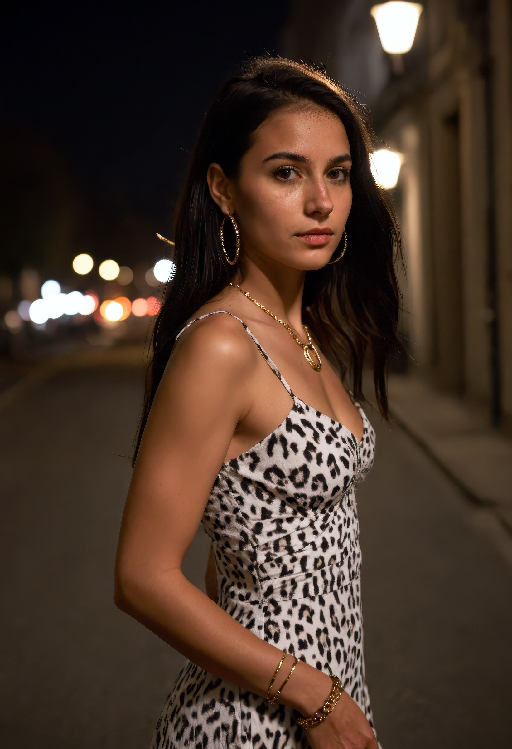 A photorealistic nighttime portrait of a petite, beautiful 29-year-old Turkish woman standing alone on a softly lit city street, side view, her slender body and youthful face framed by long flowing black hair, styled simply to reveal small mini-circle earrings, her skin pale and luminous under soft urban lighting, brown eyes glancing to the side with a shy, slightly worried expression, subtle bracelets and layered necklaces adding a touch of detail, wearing a short, sleeveless white dress with a bold leopard print pattern, bare shoulders and light visible abs, the fabric clinging naturally to her slim, petite figure, medium bust, posing with reserved allure and natural elegance, cinematic street lighting creates gentle contrast and soft glows, bracelet and jewelry sparkle subtly, mood is quiet, intimate, and atmospheric