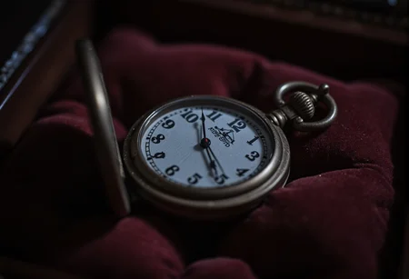 A close-up of a cracked pocket watch, its hands frozen at midnight, resting on a velvet cushion. bv-daraca<lora:bv-dark-academia-v1.safetensors:1.0:1.0>