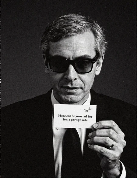 8n8log, 35mm analog black and white photo, chiaroscuro lighting, movie still, a grey haired man wearing rayban wayfarer sunglasses, he's wearing a black business suit, black tie, holdin a business card in the in one hand, he's holding the card to camera with text on it saying "Here can be your ad for a garage sale", film photography aesthetic, film grain effect prominent throughout image,  high contrast lighting creating dramatic shadows, grainy film-like texture,