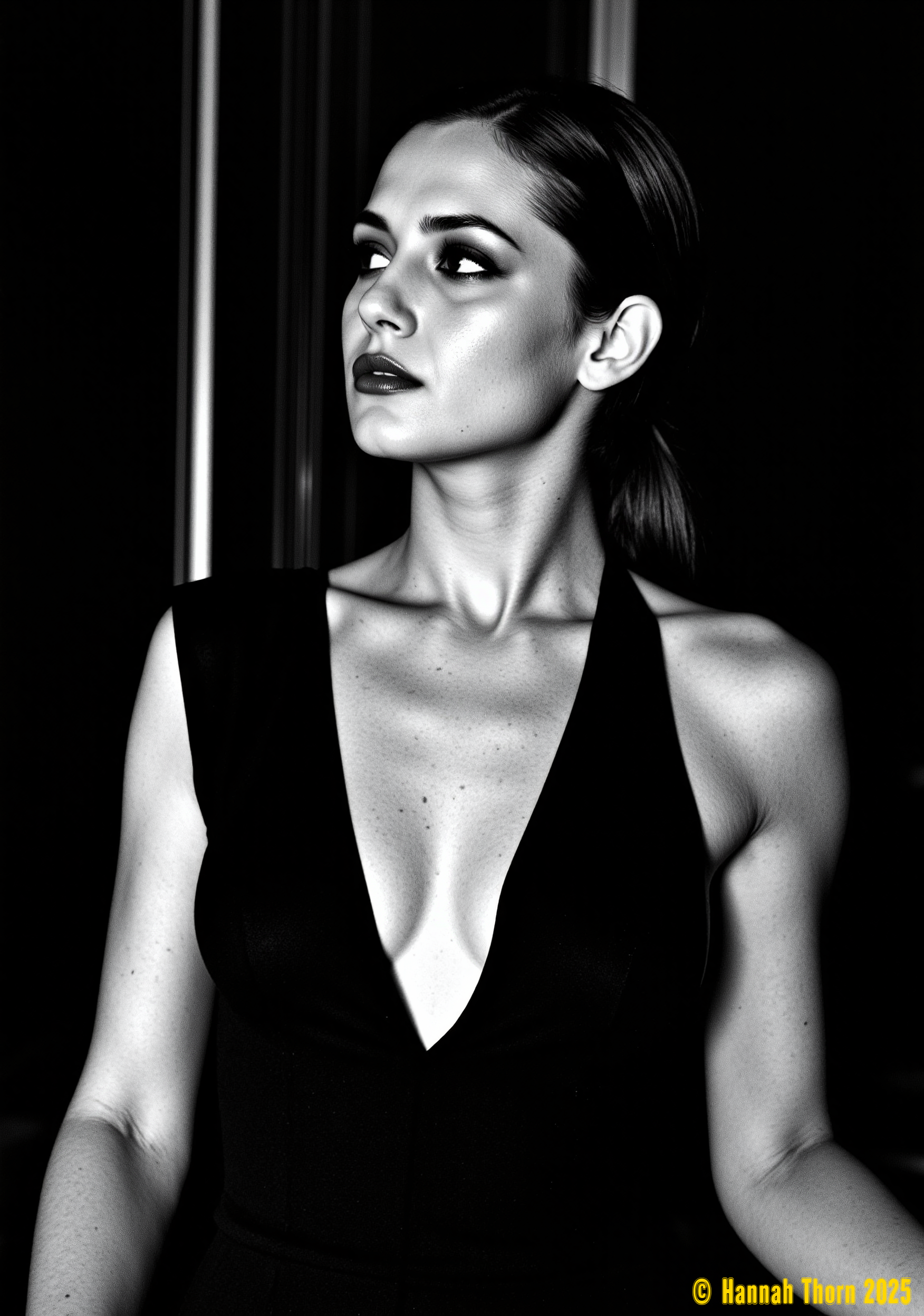 Generate a high-contrast black and white portrait, chest up, of a woman in a dark, possibly sleeveless garment with a subtly plunging neckline. Her hair is sleek, held back by a band, her expression serious and gaze averted.  The style should evoke the dramatic chiaroscuro of Rembrandt and the stark elegance of Helmut Newton, with a grainy, high-ISO film texture reminiscent of Peter Lindbergh.  Employ a shallow depth of field, blurring an indistinct dark background, focusing intently on the subject.  The monochrome palette should be rich with deep blacks and intense highlights, achieving a powerful sense of mood and mystery.  The overall aesthetic should blend the gritty realism of street photography with the sophisticated posing of fashion photography, resulting in a timeless, captivating image. <lora:_Flux\_Photographer\Helmut_Newton-000001.safetensors:0.8:0.8>