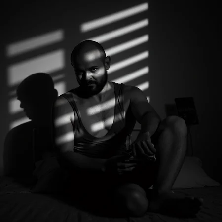 <lora:casting shadows style v1:1>
cucoloris, light modifier, casting shadows, A cucoloris patterned illumination casting a diagonal shadows on a woman sitting on a bed with a phone, solo, looking at viewer, gloves, 1boy, sitting, monochrome, greyscale, male focus, indoors, bald, cinematic, film, filmic, casting shadow, venetian blinds casting shadow light, shadow on face, face partially covered in shadow, different shadow, window casting shadow light, cinematography, detailed, detailed background, detailed face, high quality, 8k, cuculoris, kookaloris, cookaloris or cucalorus, light modifier, different light pattern, creative light, unique shadow, casting shadow style, a scene from film noir movie, holding, facial hair, blurry, mask, realistic
