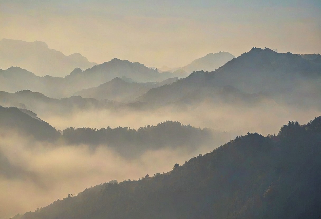 Silhouetted Misty mountains with a soft hazy sky