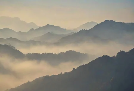 Silhouetted Misty mountains with a soft hazy sky