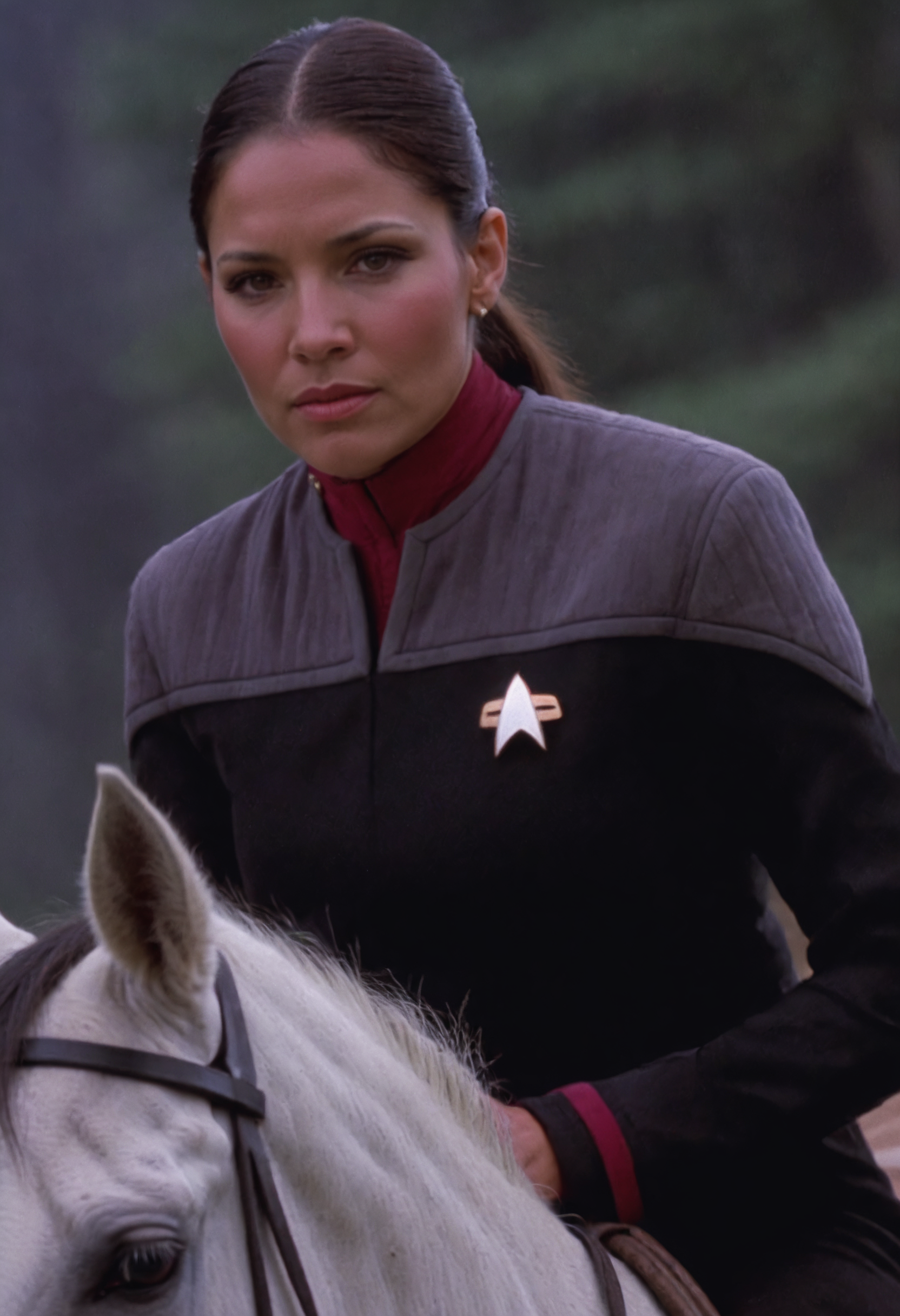native american woman on a horse, in black and grey ds9st uniform,red collar, exquisite face, details, hands, ultimate details, breathtaking grandeur<lora:DS9XLVGRAD3:0.8>