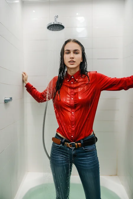 wetgirl, wet hair, wet red shirt, shirt tucked into skinny jeans, belt, looking at viewer, standing in the shower, water drop, photographed on a Fujifilm XT3, 80mm F/1.7 prime lens, cinematic film still, cinestill 500T, highly detailed, masterpiece, highest quality, intricately detailed, HDR, 8k, uhd, photorealistic, <lora:add_detail:0.5>, <lora:wetgirl:0.7>