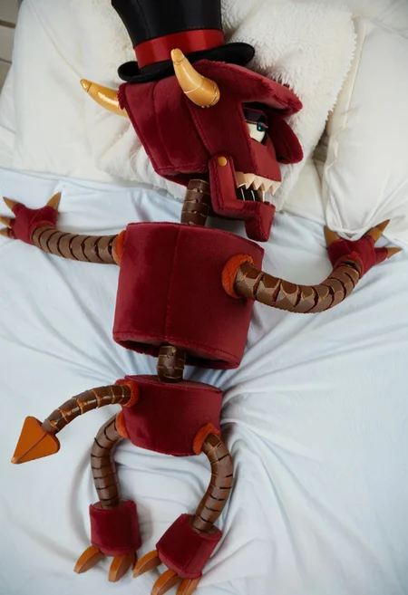 score_9, score_8_up, score_7_up, plushify, character stuffed toy, chibi, solo, plush version of a b33lz3b0t, robot, solo, bed, half-closed eyes, top hat, tail, from above