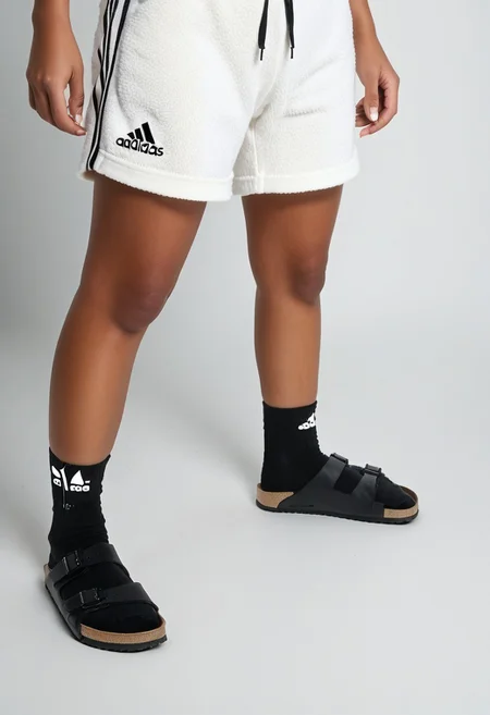 photorealistic, masterpiece, best quality.
1girl, solo, simple_background, white_background, standing.
calves, thighs, adidas_shorts, lower_body, slippers, footwear_focus, scksnsndls, birksonsocks, black_socks.