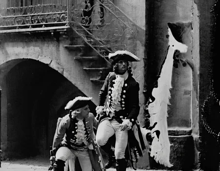 <lora:fdec:0.8>fdec man wearing 18th century clothes in front of old building
photograph from 1920s