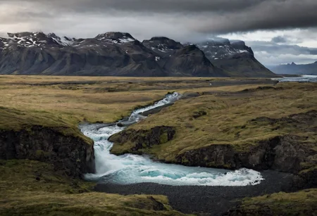 icelandic landscape, stormy weather, wide glacial valley with mountains on both sides, water streams