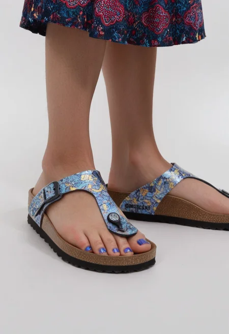 1girl, solo, simple_background, white_background, gizehonfeet, blue_toenail_polish, close-up, lower_body, footwear_focus, patterned, long_skirt