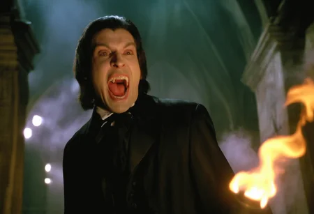 cinematic ultra close-up of a vampire man with pale skin screaming showing (fangs:1.2) lunging at the viewer ,gothic crypt torches, fog, cobwebs, dramatic chiaroscuro, low angle, creepy atmosphere <lora:h4mm3r:0.8>