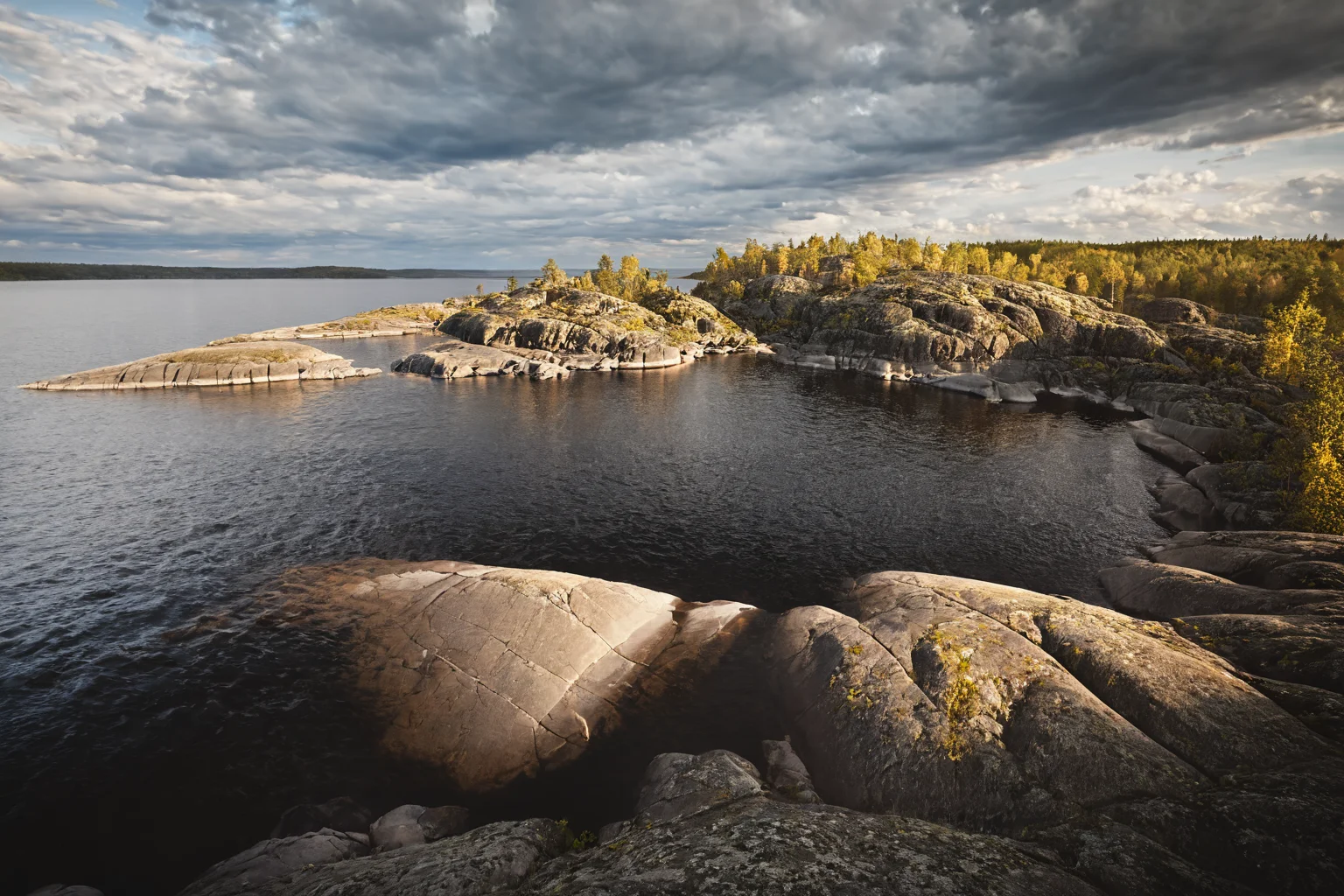 CINEMATIC SHOT, professional photo by Caravaggio of wild nature, lake ladoga, cliffs, rocks, dramatic clouds, summer, rule of thirds, (by Christopher Nolan:1.4),F11,(DOF, Cinematic Color grading, intricate, hyper realistic, detailed, flickr, cinematic lighting) <lora:Wild_nature_XL:1>
