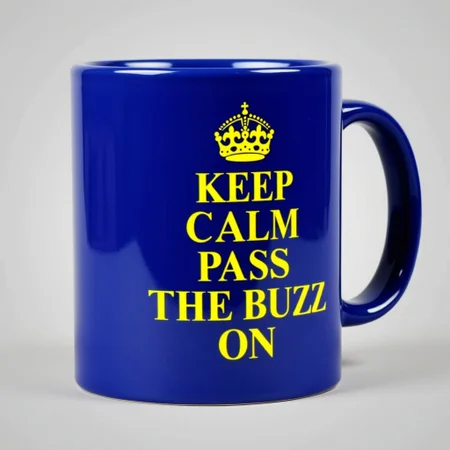 Royal blue Coffee mug that says “ KEEP CALM PASS THE BUZZ ON “ in yellow