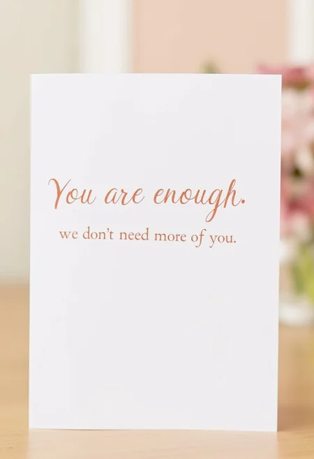 Affirmation card that says "You are enough" in bold text, and "we don't need more of you" written in script font below.
