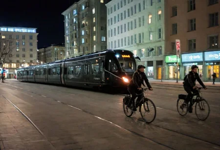 Raw photo,( shallow depth of image:1.2), (minimalistic:1.4), outdoors, wide shot of the downtown of Helsinki, tram, bike riders, night, black bullet train, 38 mm photograph, professional, FOV, HDR, natural lighting, motion blur, lowfi, KodakPhotoMaybe, photo in phst artstyle