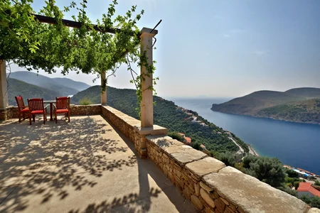 On the roof of a hillside guesthouse in northern Greece where vines creep along pergolas and coastal peaks rise in the distance. At summer midday, (bright sun:1.0) bakes the rooftop stones, a linen sheet ripples in dry wind, and the air smells of thyme. ,, Masterpiece,best quality,realistic,HDR, 8K, masterpiece, best_quality, absurdres, ultra-detailed, highly aesthetic,sweeping landscapes, unique perspectives, epic scale, revealing hidden beauty, showcasing vastness, immersive experience, precise compositions, expert piloting, dynamic angles, cinematic storytelling, showcasing natural wonders, aerial exploration