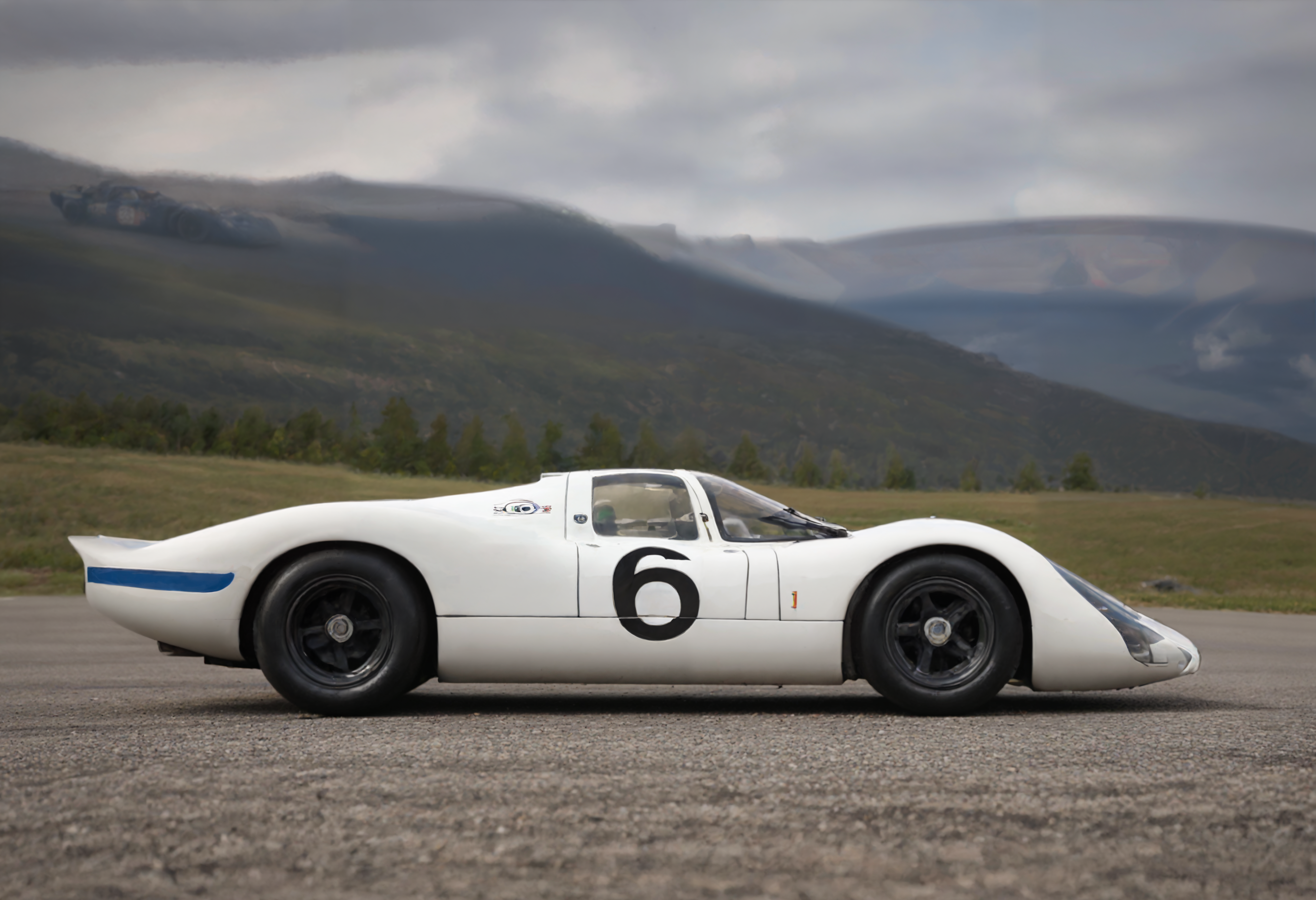 a photograph of a porsche908 sports car, l960sm1deng1ne,      Rainbow: A multicolored arc across the sky after rain, often associated with hope and promise., Violet Purple,  side view ,     Banff National Park, Canada: Majestic mountain landscapes.,   low color saturation, concept art, perfect composition, masterpiece, professional photography, zeiss lens, shot on dslr 64 megapixels, sharp focus, intricately detailed, dramatic, tilt shift,