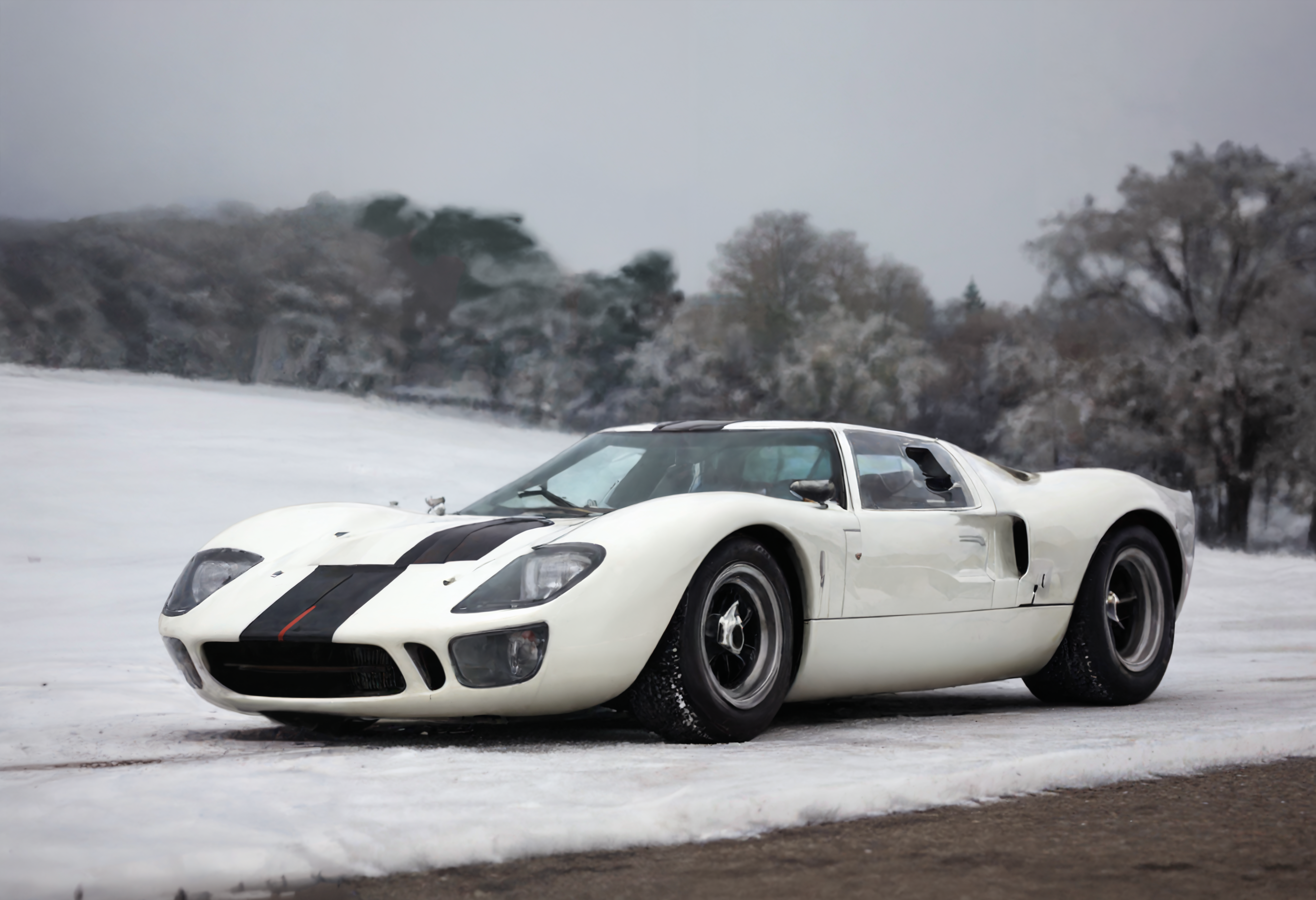 a photograph of a fordgt40 sports car, l960sm1deng1ne,      Snowfall: Blanketing landscapes in serene and pure white, offering a sense of tranquility., Toffee Brown, front 3/4 view ,     Rome, Italy: Ancient history meets modern elegance., dark chiaroscuro, low-key,   low color saturation, concept art, perfect composition, masterpiece, professional photography, zeiss lens, shot on dslr 64 megapixels, sharp focus, intricately detailed, dramatic, tilt shift,
