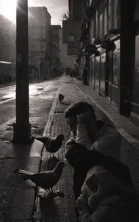 <lora:StreetPhotography_pony_v1:1> street photography, black and white,street photography \(genre\), photorealism \(style\), a couple enjoying a walk in the morning, pigeons roaming the street, score_9, score_6_up, score_7_up