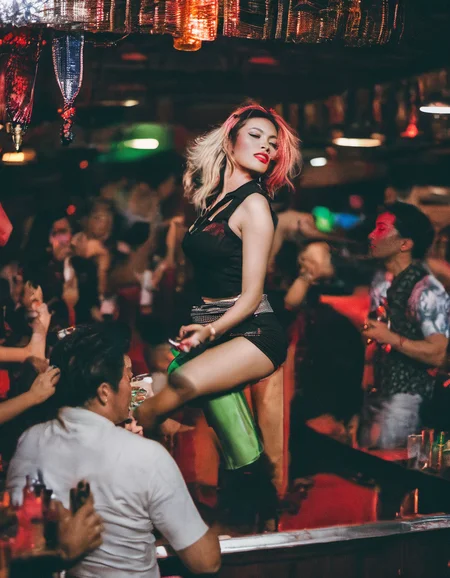 bangkok, <lora:bargirl:1.0> photo of bargirl, drinking on the dancefloor surrounded by aroused malestack sharp, professionally color graded dslr