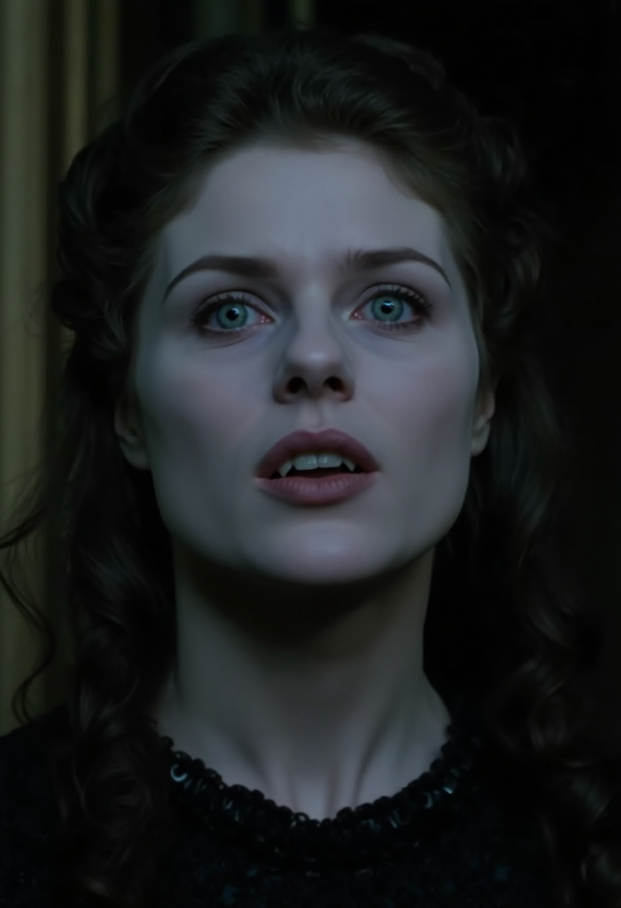 cinematic ultra close-up face shot of a young aristocratic vampire woman looking directly at the camery with a crazy, wide-eyed expression, lips slightly parted showing fangs. Extremely pale skin standing in sharp contrast to dark hair and a black silk dress, prominent cheek bones, bright detailed blue eyes, dark make-up around eyes dark victorian room in the background, at night in soft light, analogue film, IMAX, photorealistic, very detailed <lora:iwtv_flux_1_0:1>