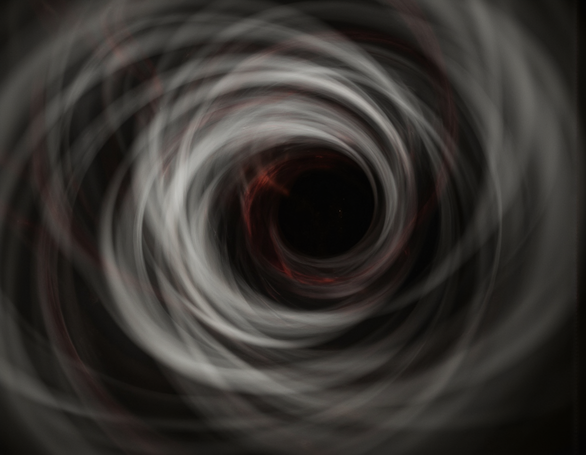<lora:Blur:0.85> blur, Eerie optical illusion, blurred motion, photorealistic, 8k, swirling vortex of muted grays and blacks, grainy texture, subtle red veins pulsing within the depths, low-key lighting emphasizing shadows, unsettling composition. . 35mm photograph, film, bokeh, professional, 4k, highly detailed