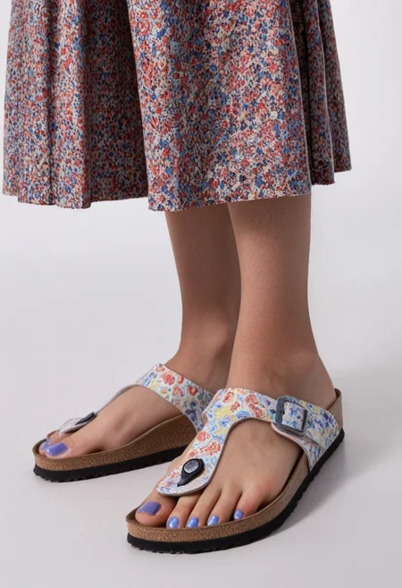 1girl, solo, simple_background, white_background, gizehonfeet, blue_toenail_polish, close-up, lower_body, footwear_focus, patterned, long_skirt