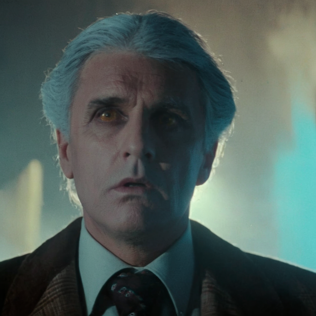 Horror-themed,  <lora:Fright Night 1985 Film Style:1>
Cinematic Closeup Shot Film Footage captured by Panavision Cameras and Lenses, Peter Vincent a grey hair man with a tie and a jacket staring at camera with a surprise look on his face and cool blue light on with dramatic shadow light on Fright Night 1985 Film Style, Eerie, unsettling, dark, spooky, suspenseful, grim, highly detailed