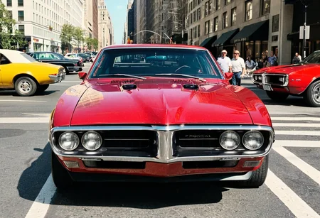 ClassicMuscleCar, gleaming Pontiac Firebird, front view, sunny, New York fifth avenue, 4K, highly detailed, (((stylish grainy analog 35mm film photo)))