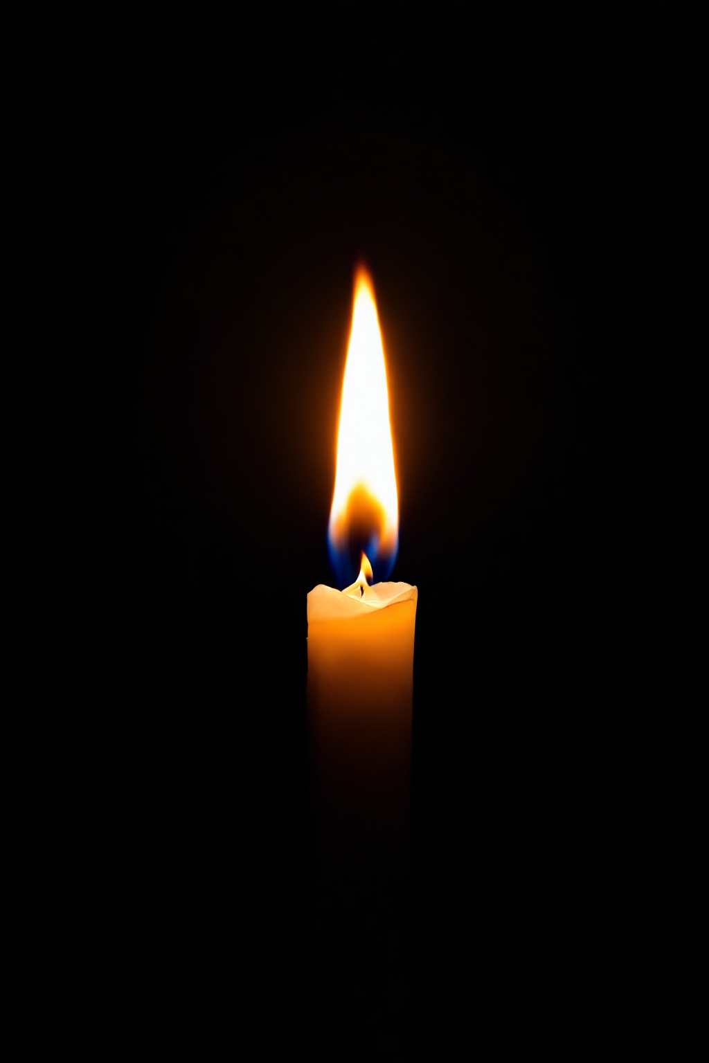 burning candle, black background
