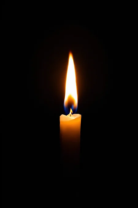 burning candle, black background