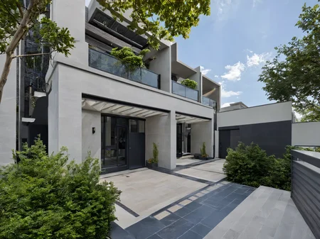 Architectural style, <lora:JJsRowHouse_XL:1>,(masterpiece) , (best quality), ((RowHouse)), dramatic lighting, high quality outdoors, sky, day, cloud, tree, blue sky, building, scenery, road, real world location, sunlight, enough detail, high resolution,super realistic, Photorealistic, highly detailed, balcony, plants, door, gate, paving, . Clean lines, geometric shapes, minimalist, modern, architectural drawing, highly detailed