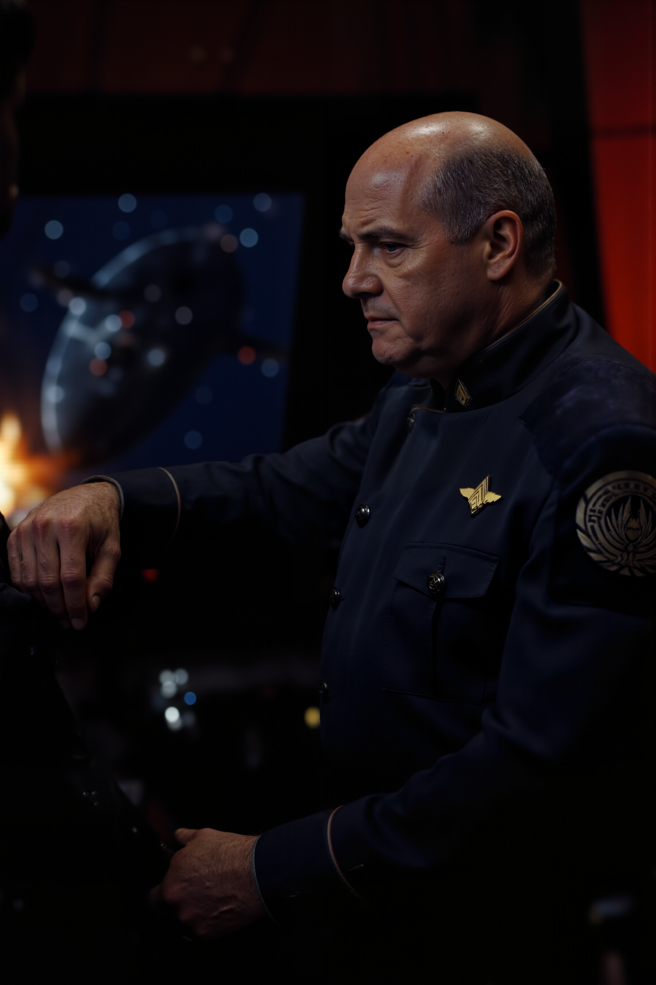 In the dimly lit command deck of a Battlestar, an officer with sharp, chiseled features and piercing blue eyes stands at the forefront of a massive viewport, gazing into the infinite blackness of space. His navy officer uniform, adorned with crisp silver insignias, is spotless, a testament to his unyielding discipline. The faint glow of tactical screens and blinking control panels reflects off the polished brass buttons of his jacket. Behind him, the faint hum of the shipâs engines reverberates through the air, accompanied by the occasional, muted voice of crew members relaying status updates. Outside, the stars stretch endlessly, their distant light dwarfed by the looming silhouette of a Cylon Basestar on the horizon. His left hand grips the edge of a console, white-knuckled, while his right hand rests on the sidearm holstered at his hip. The officerâs square jaw is set in grim determination as the faint flicker of explosions in the distance reveals a raging battle just beyond the Battlestarâs view. Around him, the deck is alive with tension, the muted red lighting creating an atmosphere of urgency. This is the moment of decision, where one command could tip the scales of a galactic war.<lora:BSG_OFFICER_FLUX:1.3><lora:aidmaMJ6.1-FLUX-V0.1:0.6><lora:Movie_Portrait><lora:Flux DetailerV2>