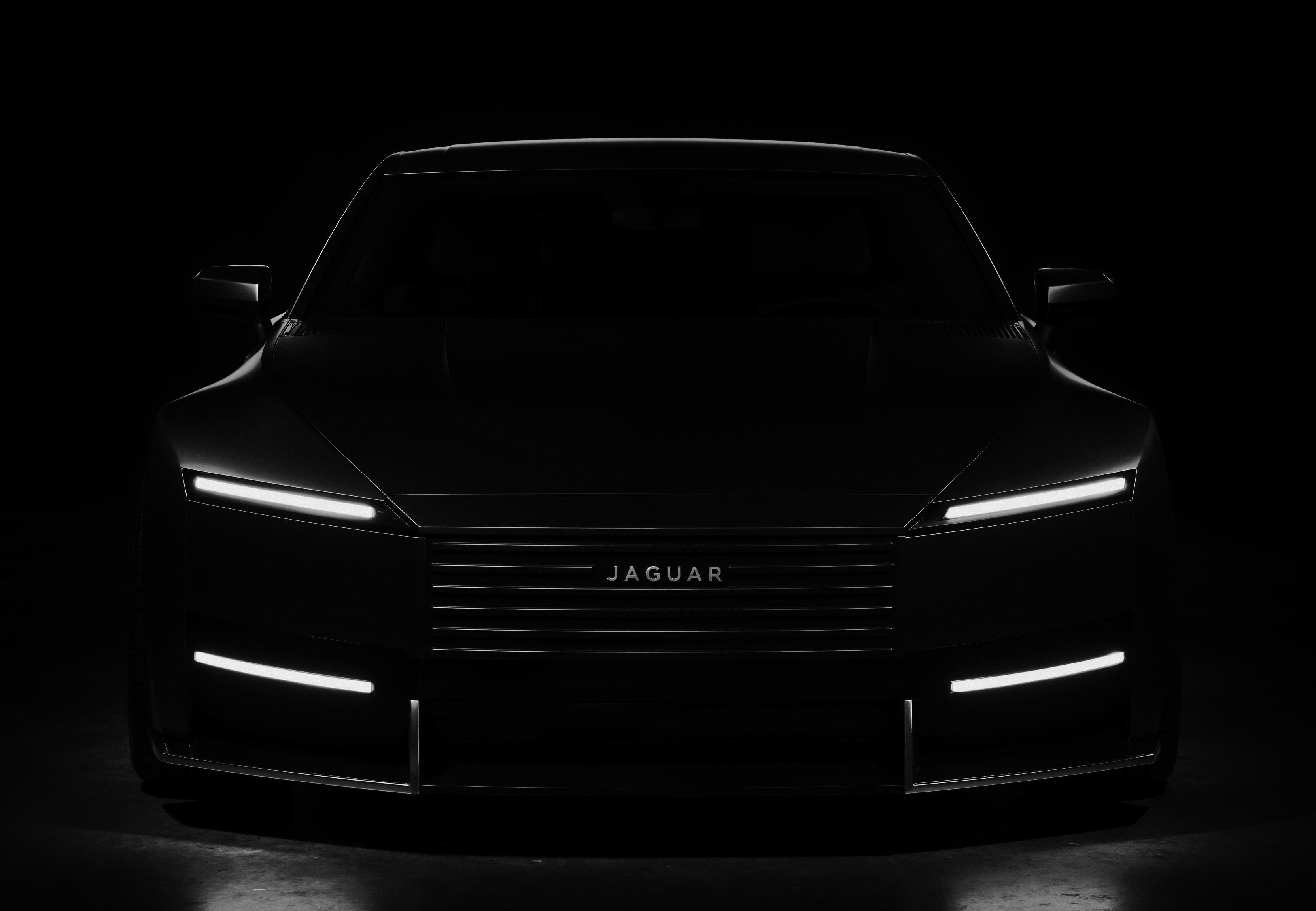 A dramatic automotive studio scene featuring a sleek black Jaguar Type against a deep black background. The car's muscular form is sculpted through strategic light painting techniques, creating precise highlights along its horizontal linear grille, slim LED headlights, and flowing body lines. The glossy black paint reflects carefully positioned studio lights, revealing the car's sculptural details while maintaining deep shadows.The logo in the Jaguar Type reads JAGUAR, The lower black fascia features subtle chrome accents that catch the light dramatically. The scene employs professional automotive lighting techniques with multiple light sources to create an edgy, kinky atmosphere, emphasizing the car's powerful presence through controlled reflections and shadow play.