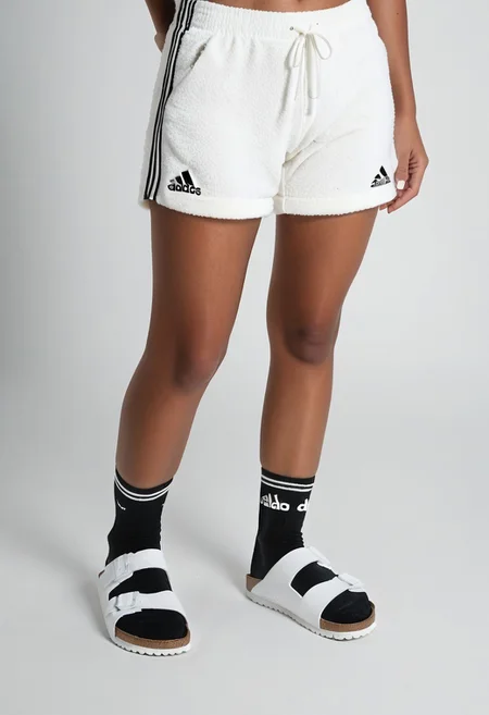 photorealistic, masterpiece, best quality.
1girl, solo, simple_background, white_background, standing.
calves, thighs, adidas_shorts, lower_body, slippers, footwear_focus, scksnsndls, birksonsocks, black_socks.