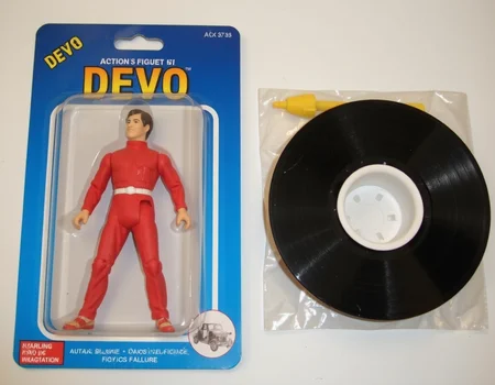 <lora:Knockoff_Toy_Twister_FLUX:1> Action Figure: The image is a photograph of a packaged action figure of (DEVO).