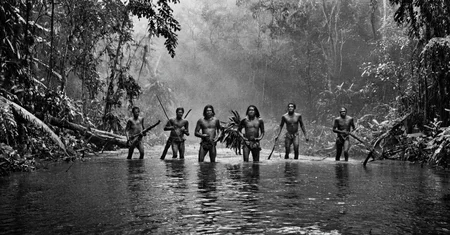 black and white photograph of few indigenous people hunting in the amazonian rain forest, insane details, dramatic lights, high definition, 35mm camera, film photography style, heavy grain, ral-chrosc-bw, masterpiece, national geographic style, strong vignette, high contrast