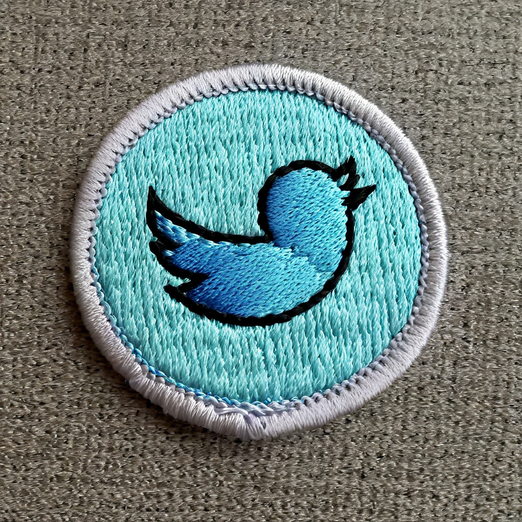 macro photograph of a circular embroidered patch of the Twitter logo , in meritbadge style, plain background, extremely detailed, contrasting complementary colors, vignette, symmetry, centered, <lora:meritbadge_StyleXLv7.0:1>