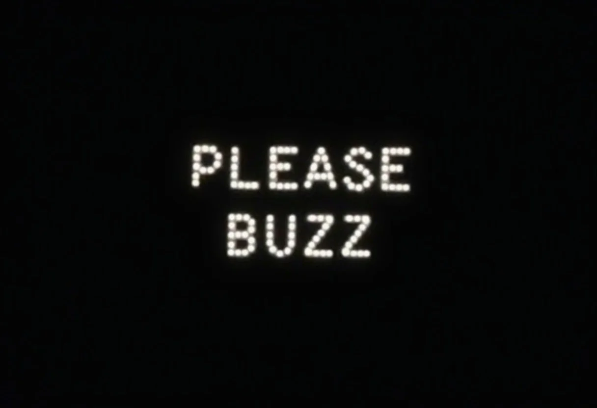 it says "please buzz" in plain white text on a black background