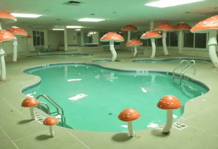 a weirdcore scene with a liminal space incorporating elements of suburbian life, creepy mushrooms, and a pool surrounded by a dirty, lo-fi atmosphere <lora:y2kmadmix_v0.0.1:1>