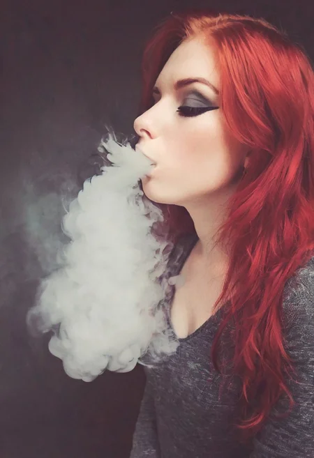 <lora:VapeXL-08:1.0> VapeXL, girl blowing smoke, red hair, eyeliner