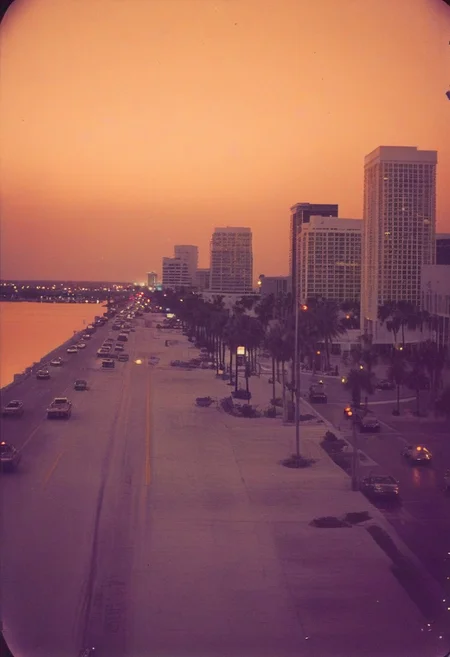 ()Hyoer Realistic:2.0)Polaroid picture 
Sahara Dust Dusk 🌆🔮 Sarasota, FL 
Twilight over the city and bayfront of Sarasota, FL mixes with the Sahara dust in the air