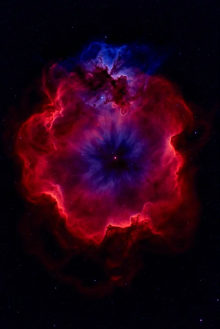 <lora:Vibrant_Nebula_2:0.8> VibrantNebula style.
The image is a high-resolution photograph of a nebula, specifically the Carina Nebula, captured in space. The nebula appears as a vast, swirling cloud of interstellar gas and dust, with colors that range from deep reds, purples, and blues. The central region is dominated by a bright, swirling red cloud, which transitions into a deep blue area around the edges. The red portions resemble a swirling, turbulent sea of clouds, with some areas appearing denser and darker, indicating more concentrated gas and dust. The blue regions, on the other hand, are less dense and more transparent, allowing more stars to shine through. Scattered throughout the nebula are numerous stars, some of which are bright and visible, while others are dimmer.