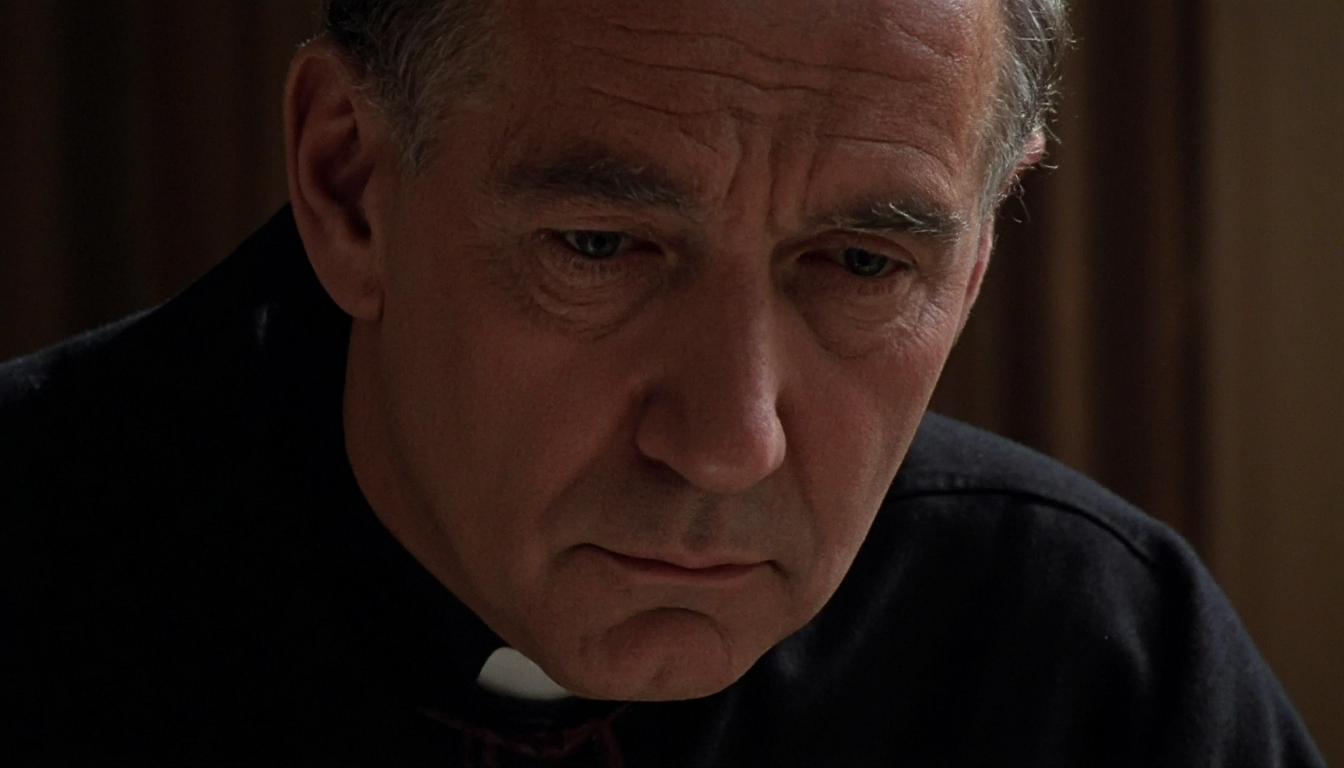 cinematic close-up of an elderly priest in a black cassock sitting in a confession booth, taken from the side. Most of his face is in the shadow, except of a beam of light shining at his eyes. Dust motes visible in the beam of light. Warm natural light. High resolution. 1980s movie <lora:dark_cinematic-000080:1>