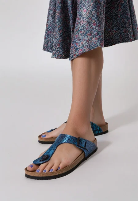 1girl, solo, simple_background, white_background, gizehonfeet, blue_toenail_polish, close-up, lower_body, footwear_focus, patterned, long_skirt