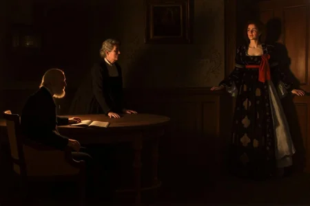 johncollier1 painting.
Two women and a man in a dimly lit room. On the left, an elderly man, shown in side profile, has a white beard and sits at a table with an open book. Behind the table stands an elderly woman, looking to the right. On the right, a young woman stands near a door in a long gown with a red ribbon. <lora:johncollier1_cap_d8a4e12:1.0><lora:850611998294069320:0>