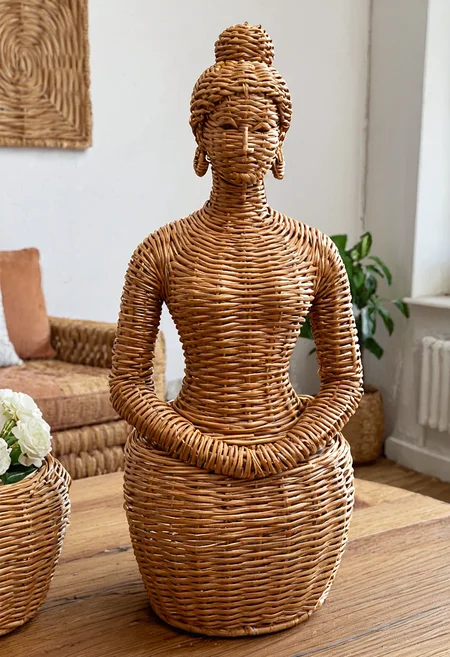 wkrstyle, a wicker female statue, a cozy living room, on the table, distant shot, wide angle shot,